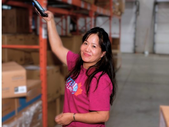 Warehouse associate scanning inventory barcode for lot control and traceability at InterFulfillment