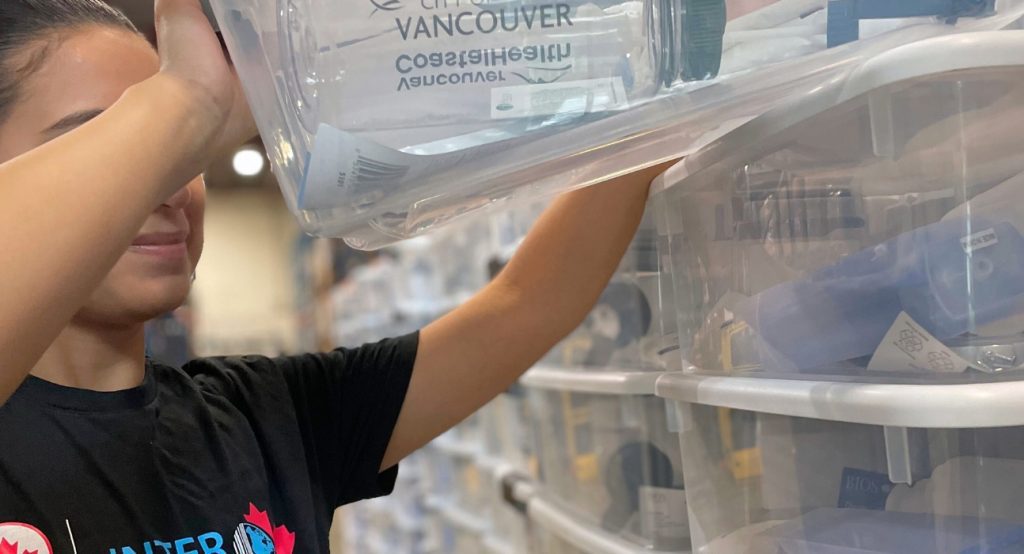 Automated conveyor system sorting packages inside a modern facility to outsource fulfillment in Canada.