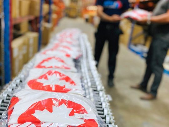 Warehouse worker picking apparel and lifestyle products for order fulfillment in Canada