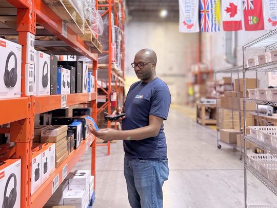 InterFulfillment's Warehouse worker scanning serial numbers for consumer electronics fulfillment Canada orders.