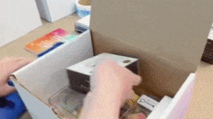 Warehouse staff packaging delicate consumer electronics into protective shipping boxes at an InterFulfillment distribution center in Canada