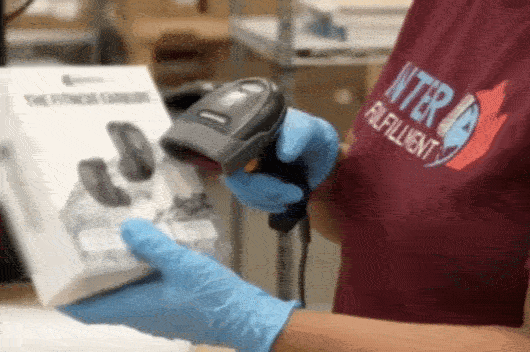 Warehouse worker scanning direct-to-consumer packages for parcel shipping 3PL Canada dispatch