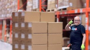 Warehouse team member scanning master cartons for case-level picking and purchase order fulfillment